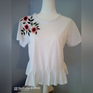 Chelsea & Theodore white top with pretty flowers on right shoulder.